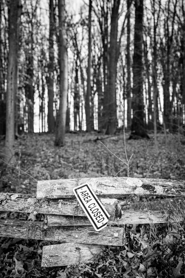 A fence at Valley Forge, with an "area closed" sign hanging from it.