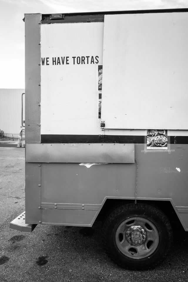 The back of a food truck with a sign that reads "we have tortas".