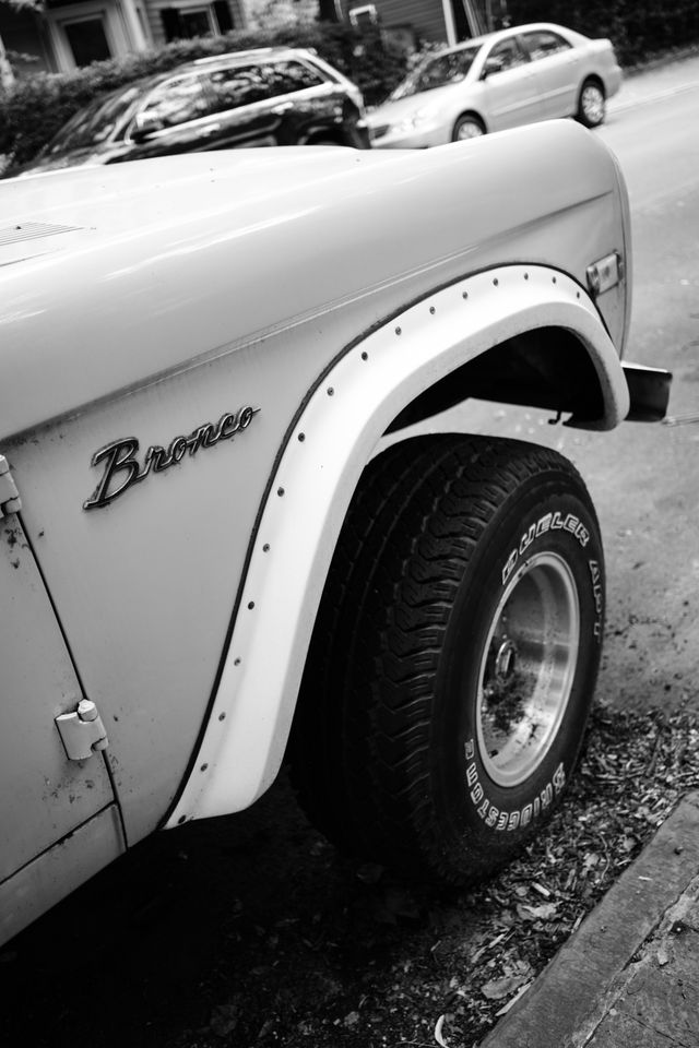 The badge on the front right side of a classic Ford Bronco in Capitol Hill.