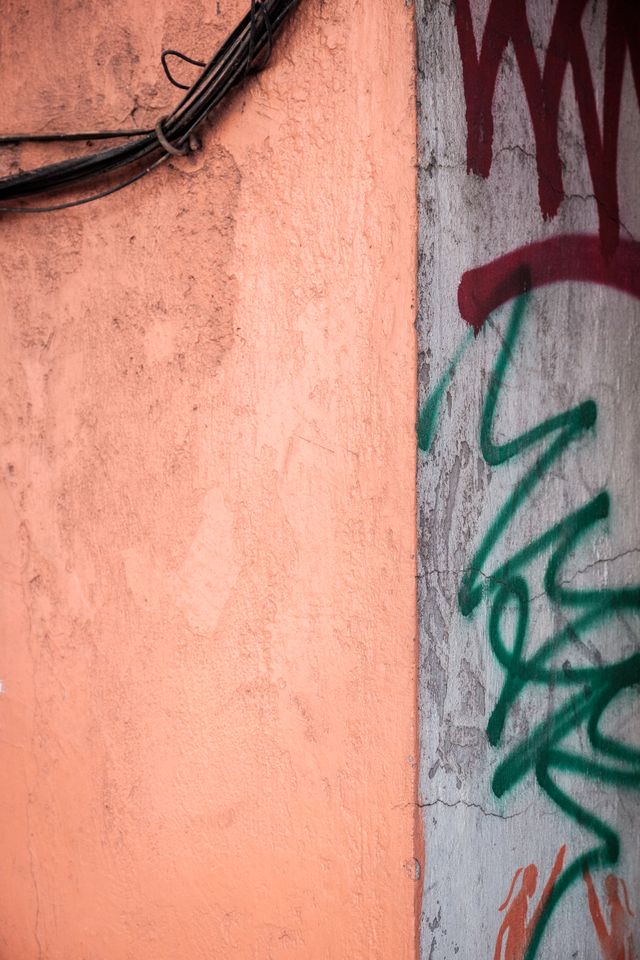 Old colorful graffiti'd wall in Mexico City.