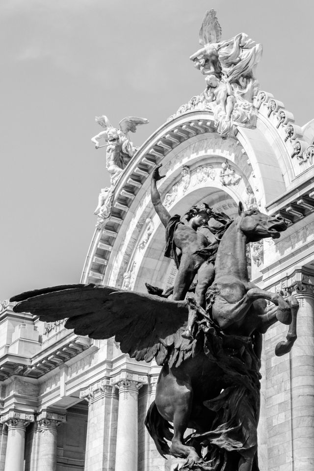 One of the statues in front of the Palacio de Bellas Artes in Mexico City.