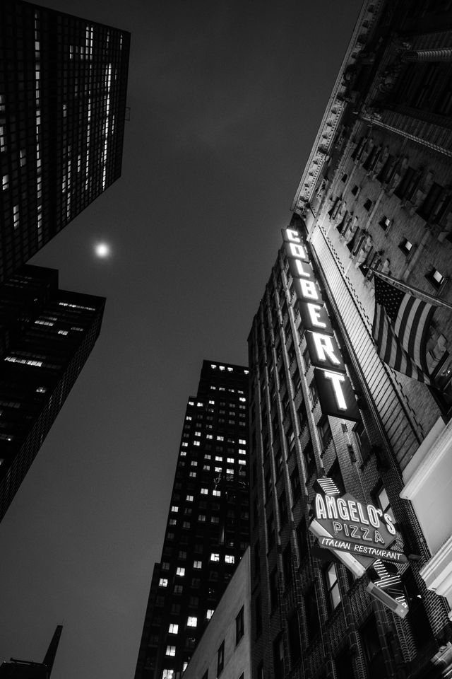 Looking up at the Colbert sign at the Ed Sullivan Theater, at night.