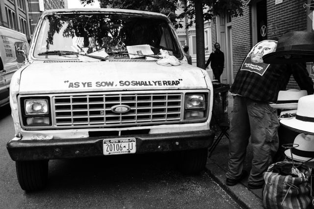 An old Ford van in Soho, which has "as ye sow, so shall ye reap" written on the hood.