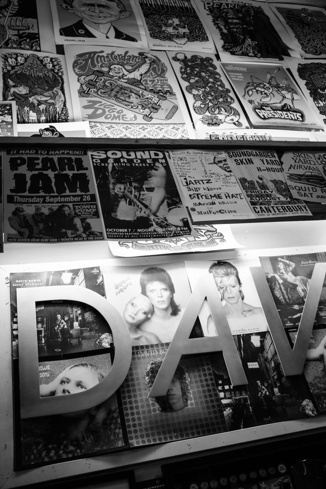 Concert & album posters for Pearl Jam, Soundgarden, David Bowie, and others, on a wall at Easy Street Records in Seattle.