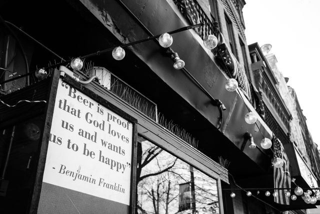 A sign that reads "Beer is proof that God loves us and wants us to be happy", credited to Benjamin Franklin.