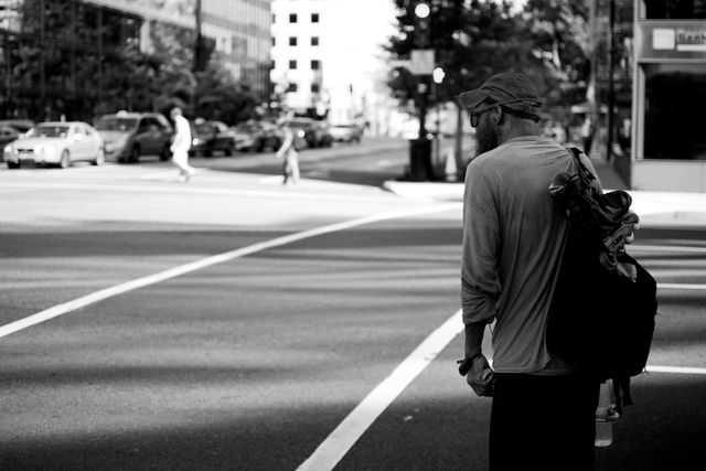 A pedestrian waiting for the light to change near Farragut Square.