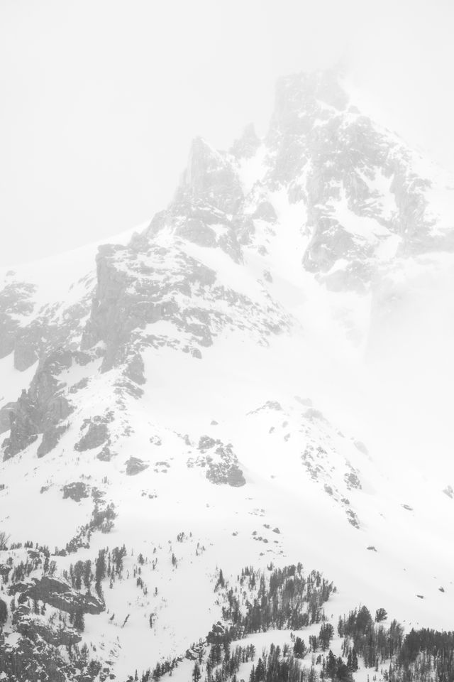 Close-up of Grand Teton, partially covered in clouds.