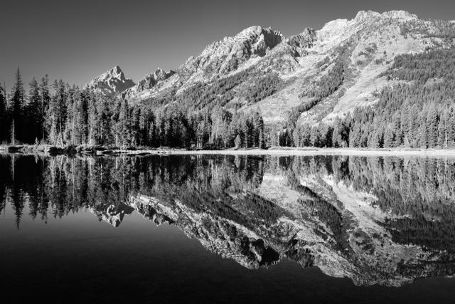 The Teton range, including Symmetry Spire and Teewinot Mountain, seen reflected on the surface of String Lake.