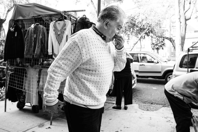 A man scratching his nose while walking on the Avenida Álvaro Obregón in Mexico City.