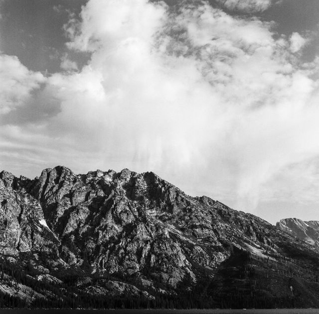 The Tetons, seen under clouds from Jenny Lake.