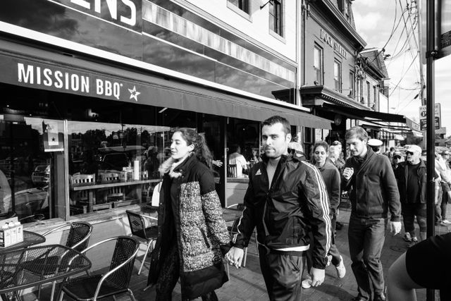 Pedestrians on the street in front of Mission BBQ in Annapolis, Maryland.