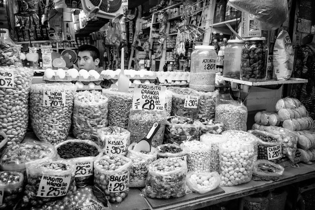 A vendor selling granola, nuts, snacks and other foodstuff in Coyoacán Market.