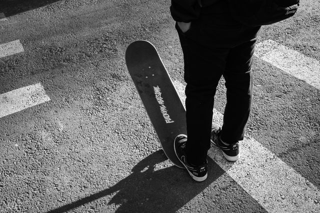 A guy on a skateboard with a "fucking awesome" sticker on it.