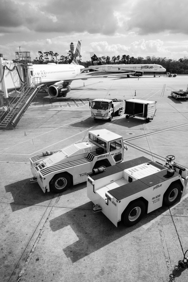 A couple of tugs next to a gate at Orlando International Airport.