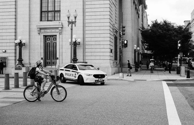 A cyclist waiting for the light to change on Pennsylvania Avenue, near the White House.