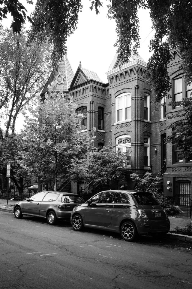 Two cars parked in front of row houses in Capitol Hill.