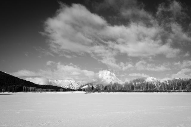 Mount Moran, seen under partly cloudy skies from a still-frozen Oxbow Bend.