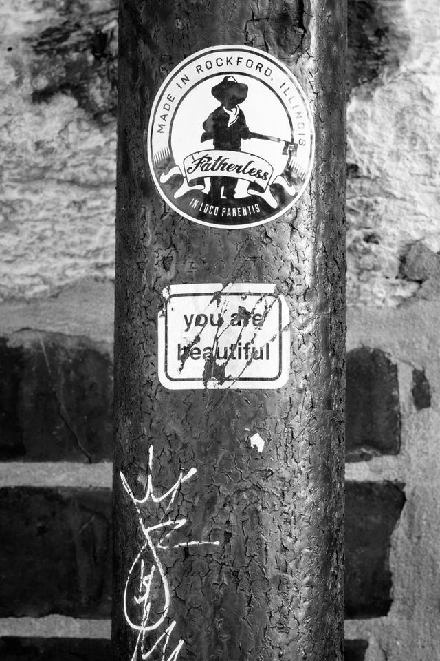 A sticker on a pipe, that says "you are beautiful".