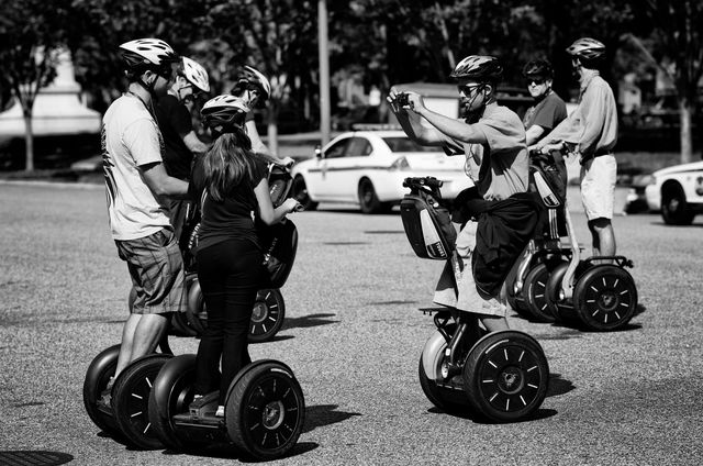 Tourists on Segways posing for photos at the White House.