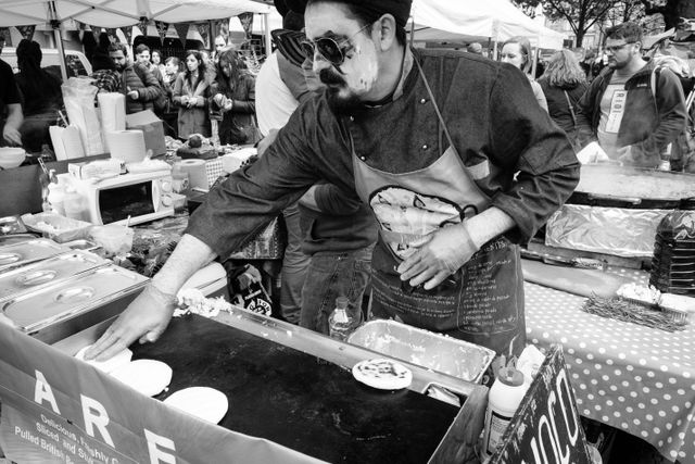 A man cooking arepas at Grassmarket, Edinburgh.