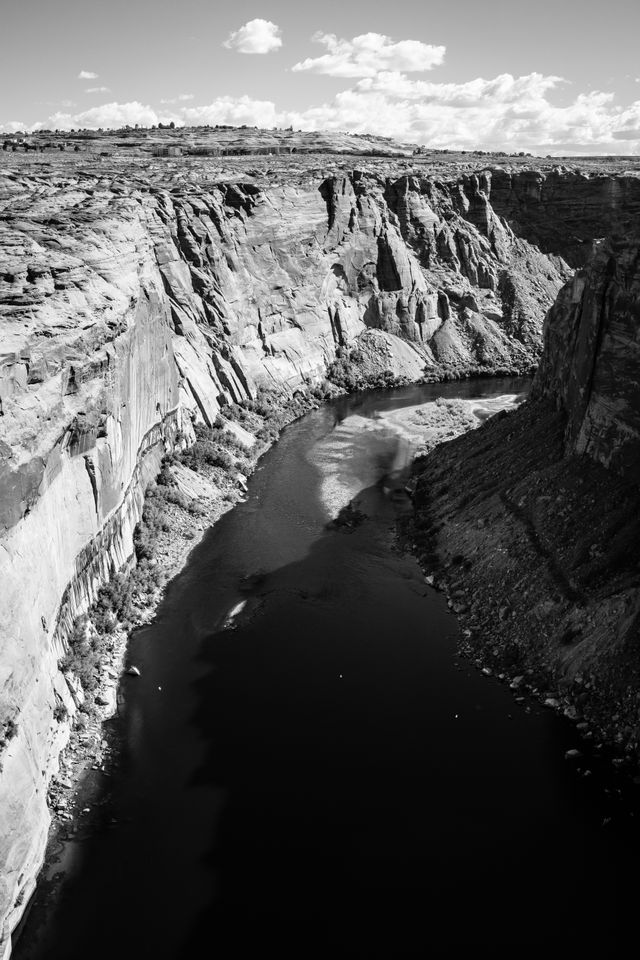 Glen Canyon and the Colorado river, seen downstream from the dam, from the Glen Canyon Bridge. At the top of the canyon in the background, buildings in Page, Arizona.