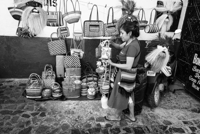 A woman selling baskets and handbags on the street in Taxco.