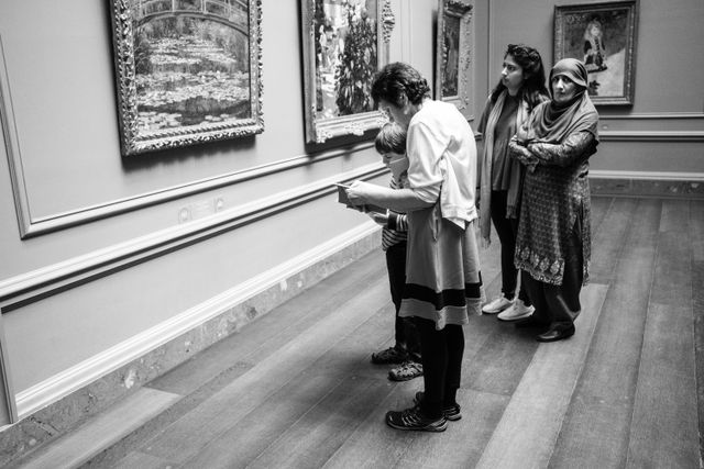 A group of people looking at artwork at the National Gallery of Art in Washington, DC.