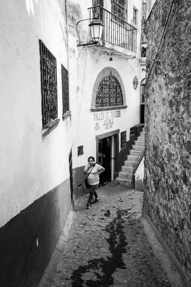 A woman walking in an alley in Taxco.