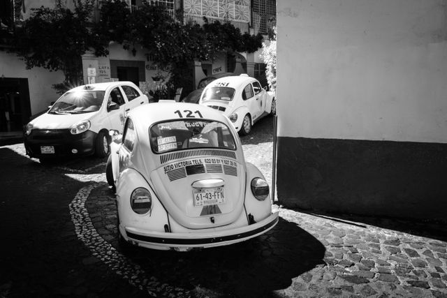 A line of VW taxis turning a corner in Taxco.