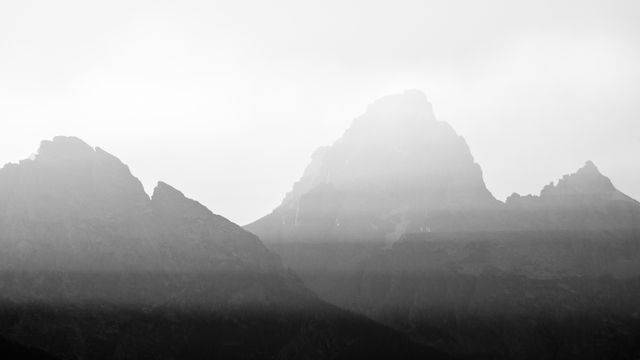 Nez Perce Peak, Grand Teton, and Mount Owen, at sunset. Streaks of sunlight are visible in the smoke from the California wildfirs.