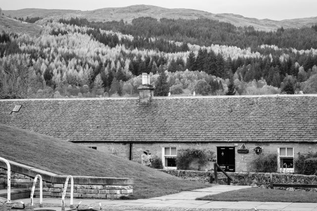 A woman in a hat walking along the Caledonian Canal in Fort Augustus.