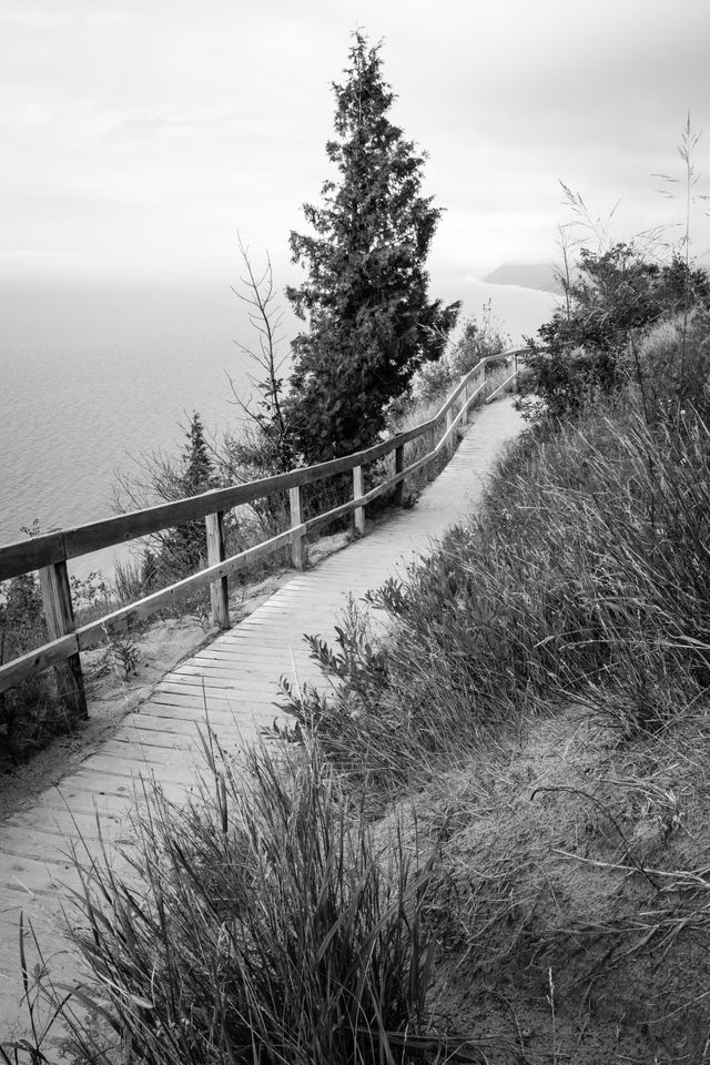 The wooden trail near the top of Empire Bluff, with Lake Michigan and Sleeping Bear Dunes in the background.