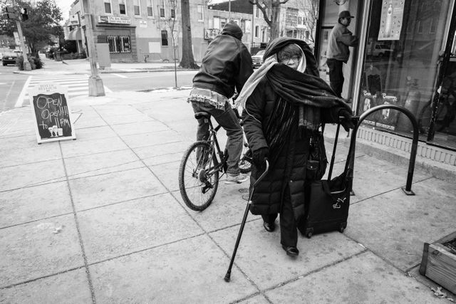 A woman walking past a liquor store on Pennsylvania Avenue SE.