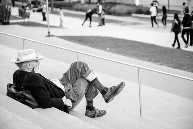 An old gentleman enjoying the cool breeze on the steps of the Soumaya Museum in Mexico City.