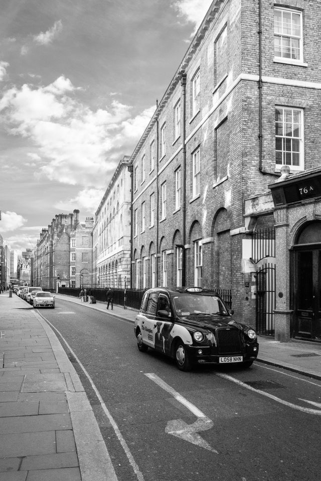 A taxi driving down Chancery Lane in London