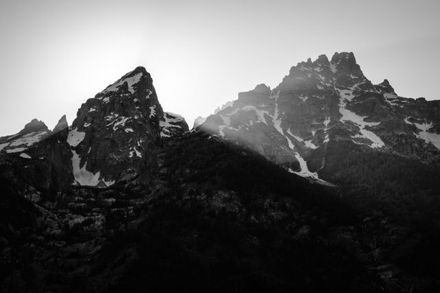 The sun setting behind Grand Teton and Teewinot Mountain.