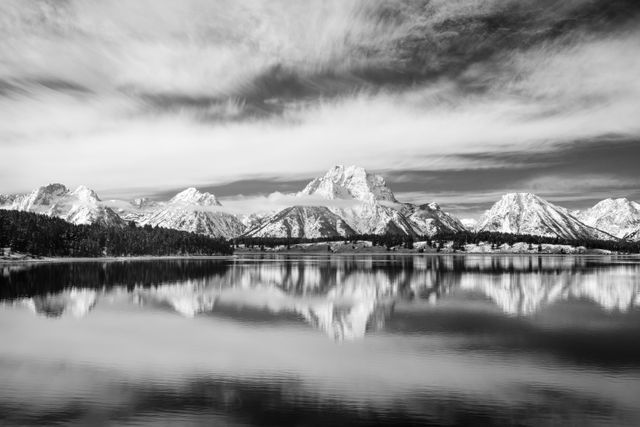 Mount Moran and other mountains in the Teton Range reflected off the surface of Jackson Lake.