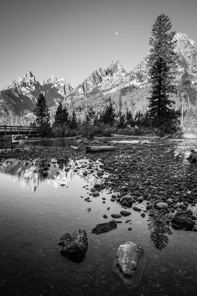 Rocks in the String Lake outlet. In the background, Teewinot Mountain, Grand Teton, Mount Owen, and Symmetry Spire.