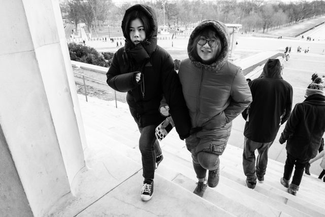 Two women climbing the stairs of the Lincoln Memorial.