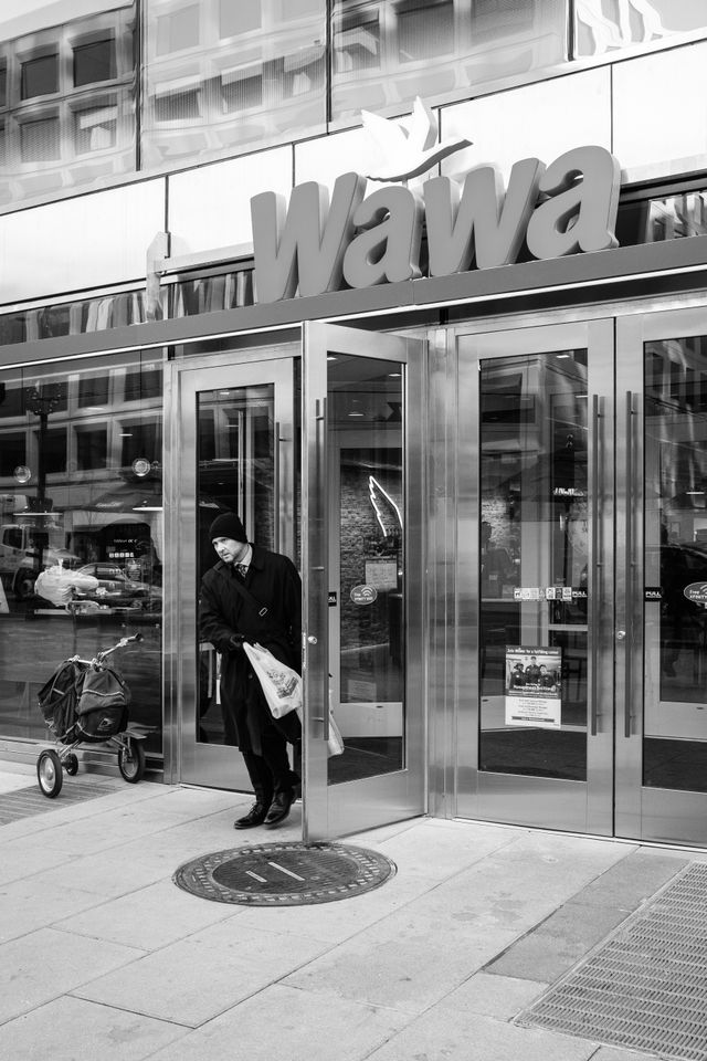 A man walking out of the Wawa on 19th Street NW in Washington, DC.