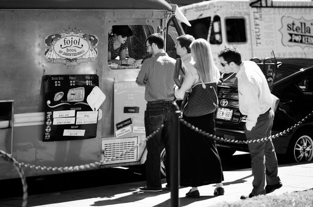 People standing in line at a food truck on Farragut Square.