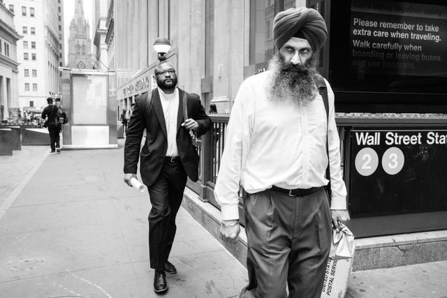 A Sikh man walking on Wall Street in New York.