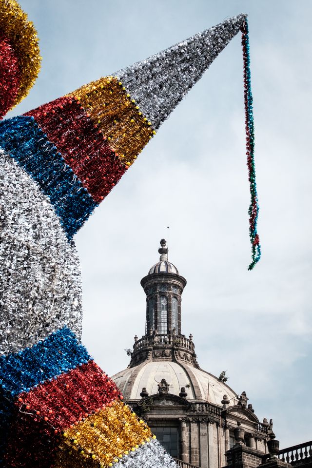 A massive piñata in the Zócalo, with the Catedral Metropolitana of Mexico City in the background.