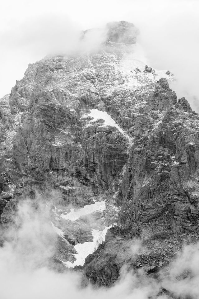 Grand Teton, partially covered by clouds, and sporting a fresh dusting of snow near its summit, the first of the season.