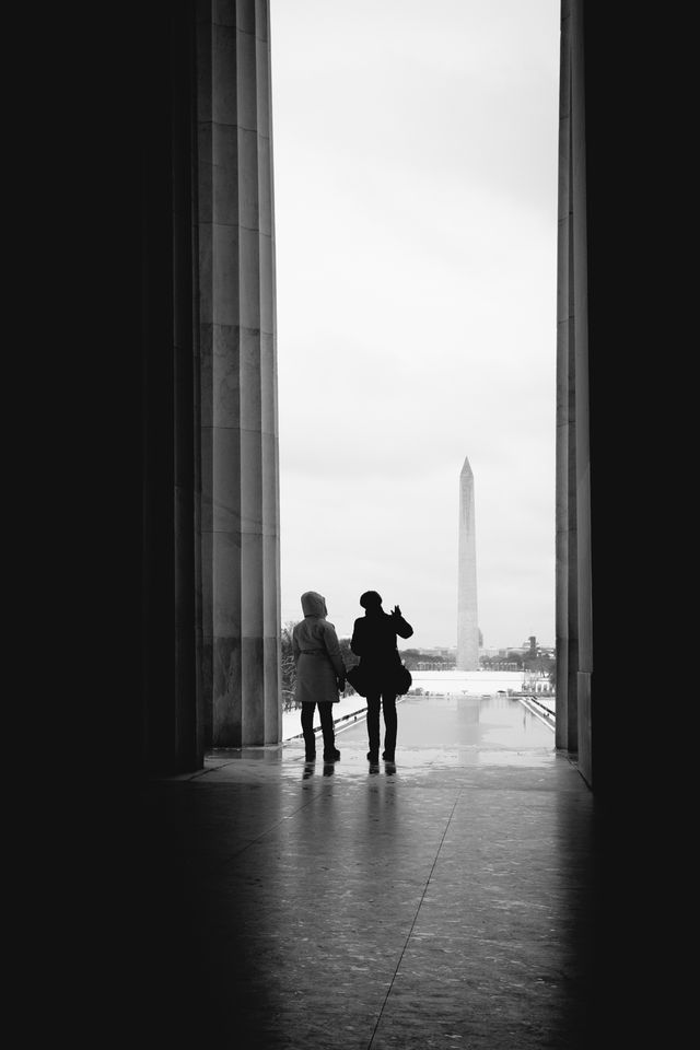 Tourist looking at the Washington Monument from the Lincoln Memorial.