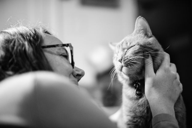 Kate, rubbing Rusty's cheek while he closes his eyes, obviously enjoying it.