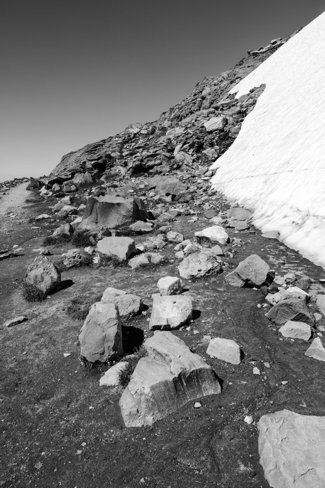 A big chunk of glacier next to boulders near the top of the Skyline Trail in Mount Rainier National Park.