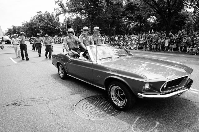 Three Park Rangers riding on a Mustang at the Independence Day Parade in Washington, DC.