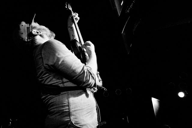 Scott Hutchison playing guitar at a Frightened Rabbit concert at Black Cat.