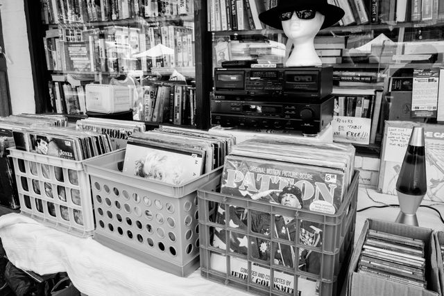 Vinyl albums and used books on a table at Capitol Hill Books.